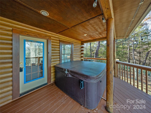 wooden deck featuring a hot tub