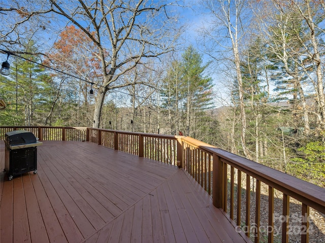 wooden terrace featuring area for grilling