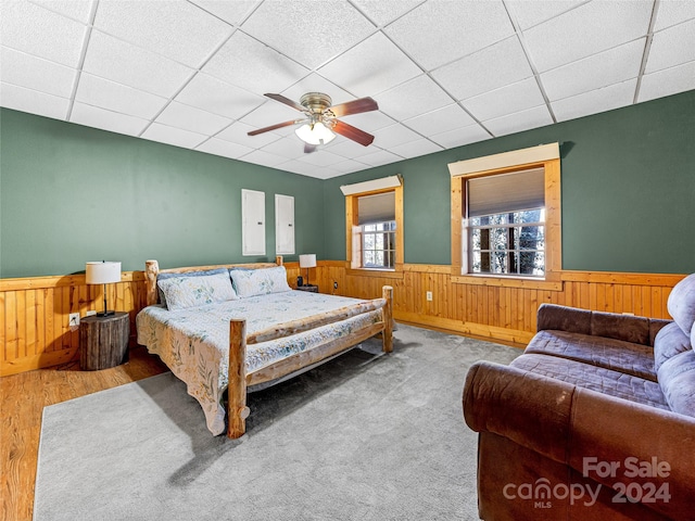 bedroom with a paneled ceiling, ceiling fan, and wood-type flooring