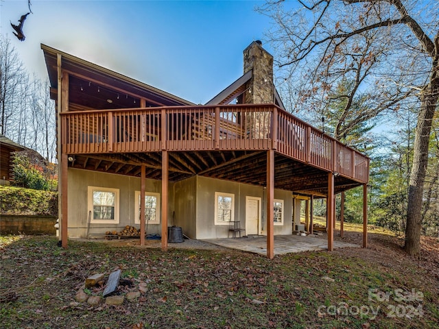 back of property featuring a patio and a deck