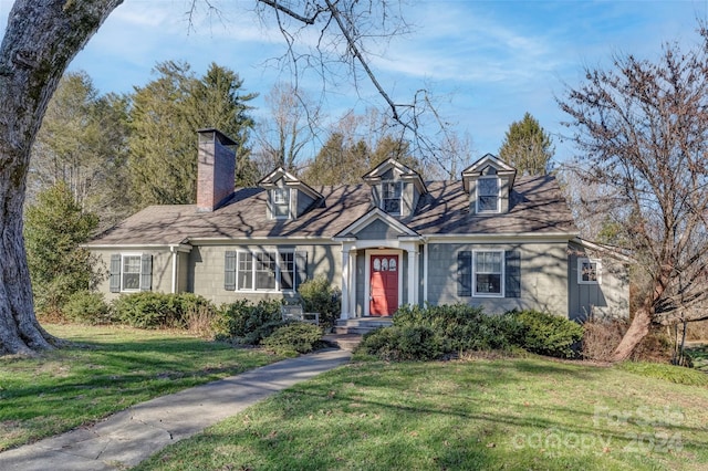 cape cod house with a front yard