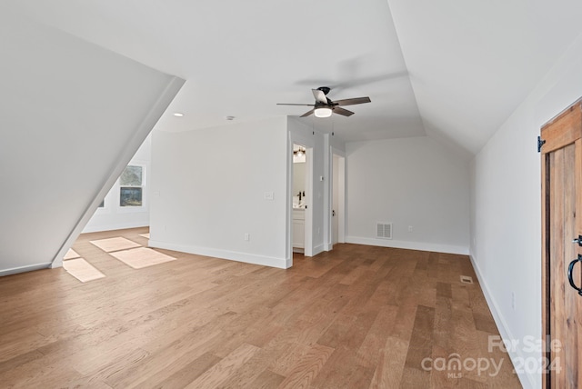 bonus room with ceiling fan, light hardwood / wood-style flooring, and vaulted ceiling