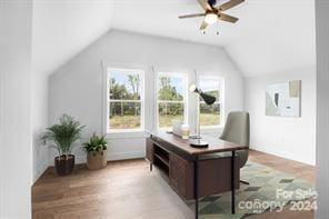 office area with light hardwood / wood-style floors, vaulted ceiling, a wealth of natural light, and ceiling fan