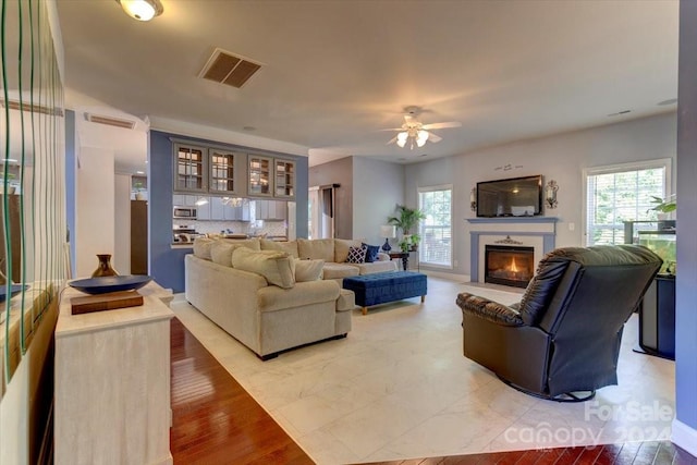 living room with ceiling fan and hardwood / wood-style flooring