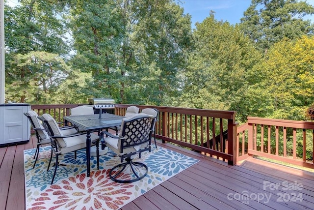 wooden terrace featuring a grill