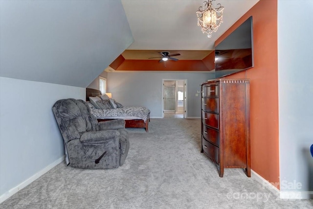 carpeted bedroom with ceiling fan with notable chandelier, connected bathroom, and vaulted ceiling