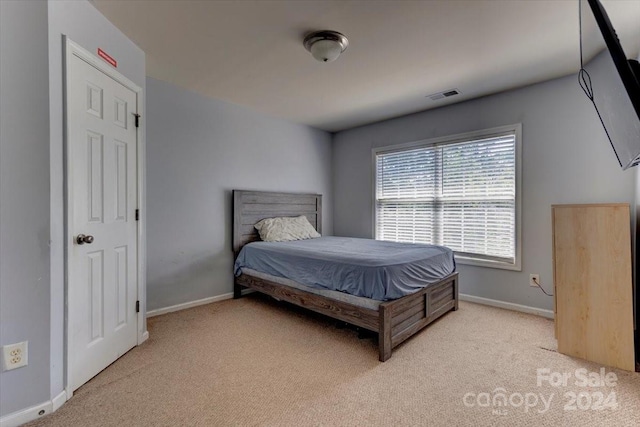 bedroom featuring light carpet