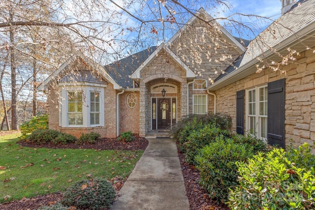 doorway to property with a yard