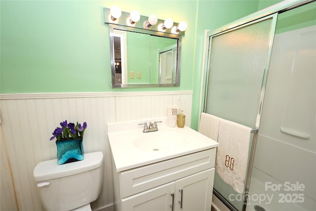 bathroom featuring vanity, toilet, and walk in shower