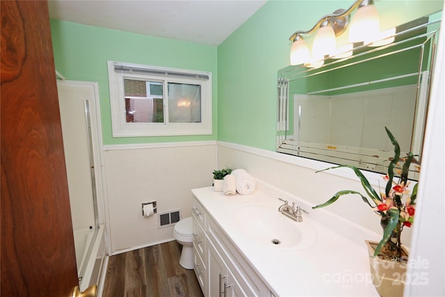 bathroom featuring hardwood / wood-style flooring, vanity, and toilet