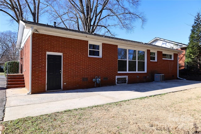 rear view of property featuring central air condition unit and a patio area