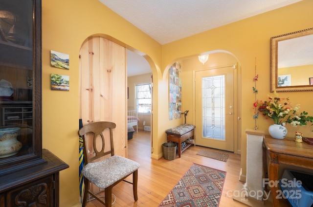 entryway with a textured ceiling and hardwood / wood-style floors