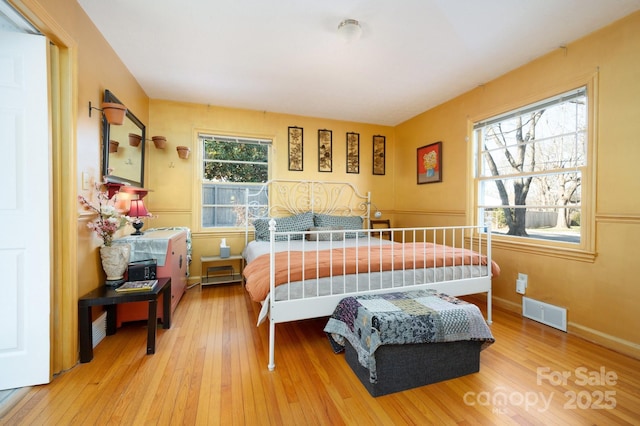 bedroom with hardwood / wood-style flooring