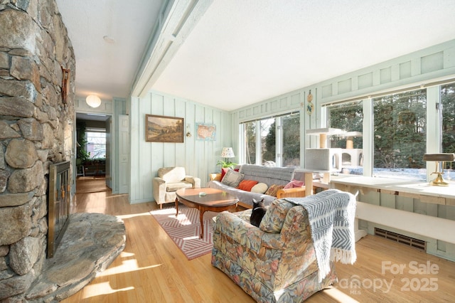 living room with vaulted ceiling and light hardwood / wood-style floors