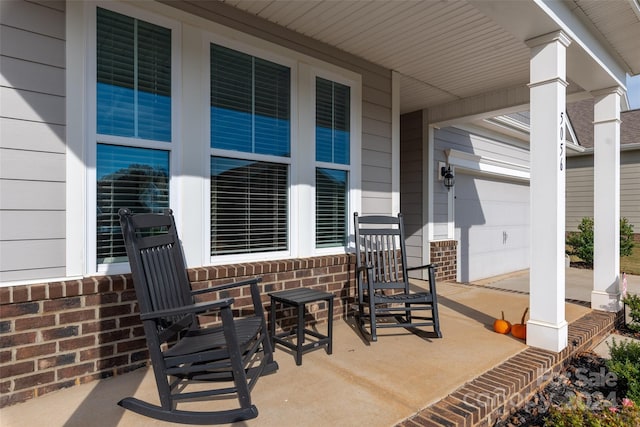 view of patio featuring a garage and covered porch