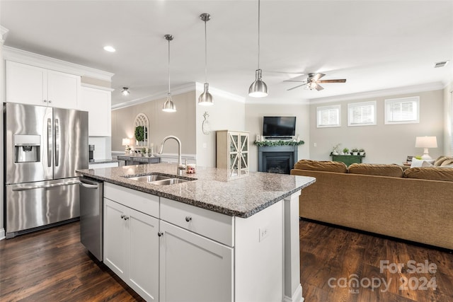 kitchen featuring sink, dark wood-type flooring, a kitchen island with sink, white cabinets, and appliances with stainless steel finishes