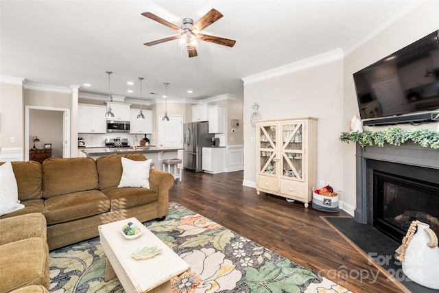 living room with dark hardwood / wood-style floors, ceiling fan, ornamental molding, and sink