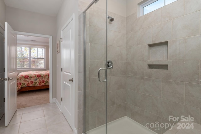 bathroom featuring tile patterned flooring and a shower with door