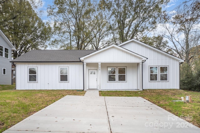 view of front of house with covered porch and a front yard