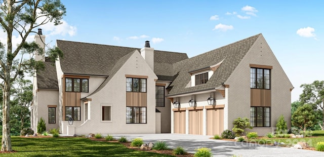 view of front of property featuring a garage and a front lawn