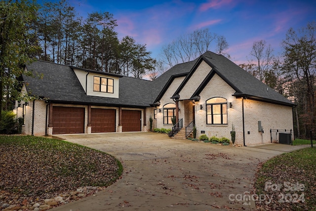 french country inspired facade featuring a garage