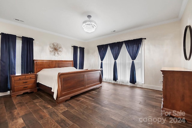 bedroom with dark hardwood / wood-style flooring, crown molding, and a notable chandelier