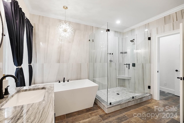 bathroom featuring sink, ornamental molding, shower with separate bathtub, a notable chandelier, and wood-type flooring