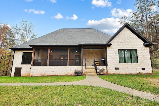 view of front facade featuring a sunroom and a front lawn