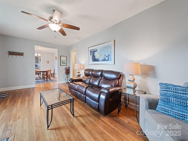 living room with ceiling fan and wood-type flooring