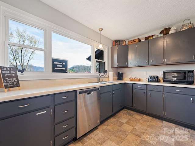 kitchen featuring dishwasher, pendant lighting, a textured ceiling, and sink