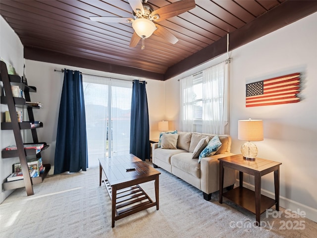 carpeted living room featuring ceiling fan, a healthy amount of sunlight, and wooden ceiling