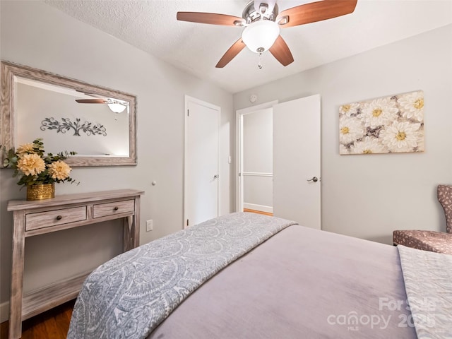 bedroom with a textured ceiling and ceiling fan