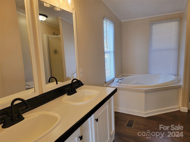 bathroom with vanity, hardwood / wood-style flooring, ornamental molding, a textured ceiling, and independent shower and bath