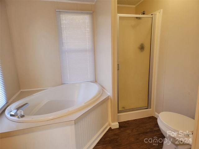 bathroom with ornamental molding, toilet, wood-type flooring, and shower with separate bathtub