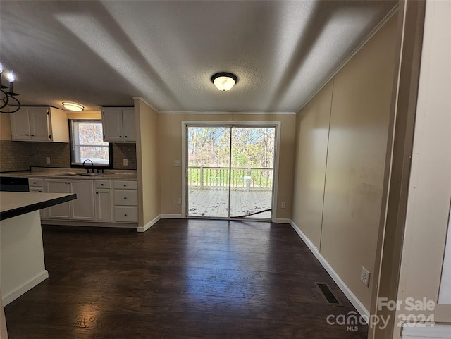 kitchen featuring white cabinetry, a wealth of natural light, and dark hardwood / wood-style floors