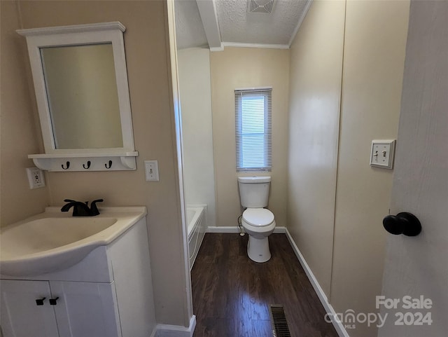 bathroom featuring crown molding, a textured ceiling, toilet, vanity, and hardwood / wood-style flooring