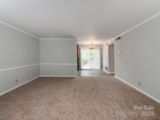 carpeted empty room with ornamental molding and a notable chandelier