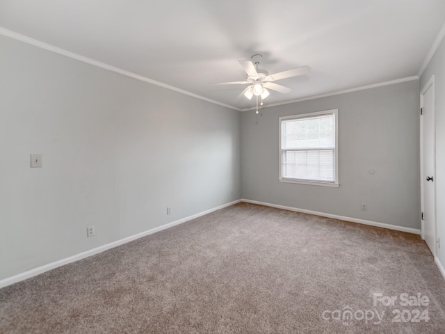 carpeted empty room featuring ceiling fan and crown molding