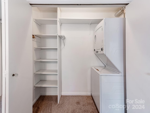 laundry area with light carpet and stacked washer and clothes dryer