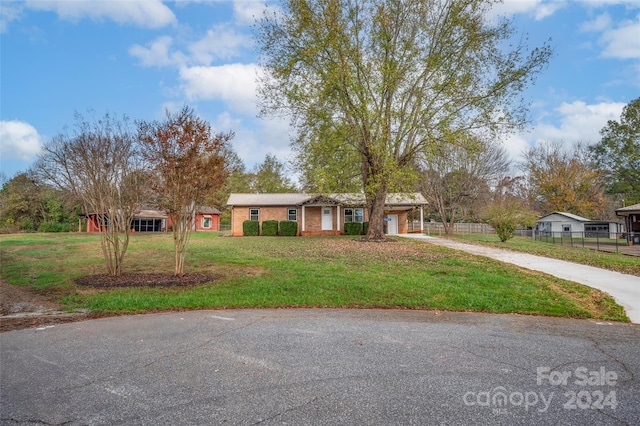 ranch-style house with a garage and a front lawn