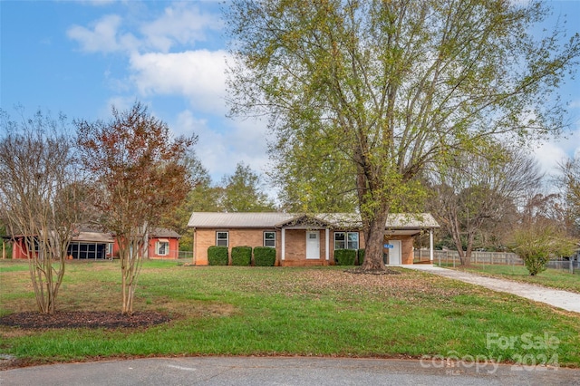 ranch-style house featuring a front lawn and a garage