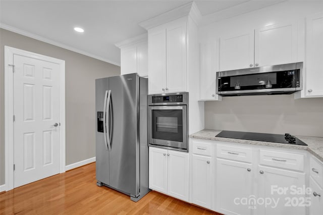 kitchen with ornamental molding, appliances with stainless steel finishes, light stone countertops, light hardwood / wood-style floors, and white cabinets