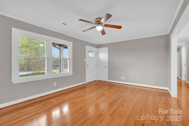 spare room with light hardwood / wood-style flooring, ornamental molding, and ceiling fan