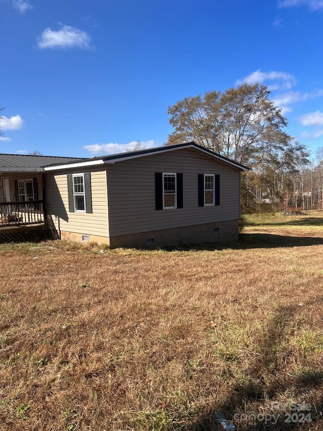 view of property exterior featuring a lawn