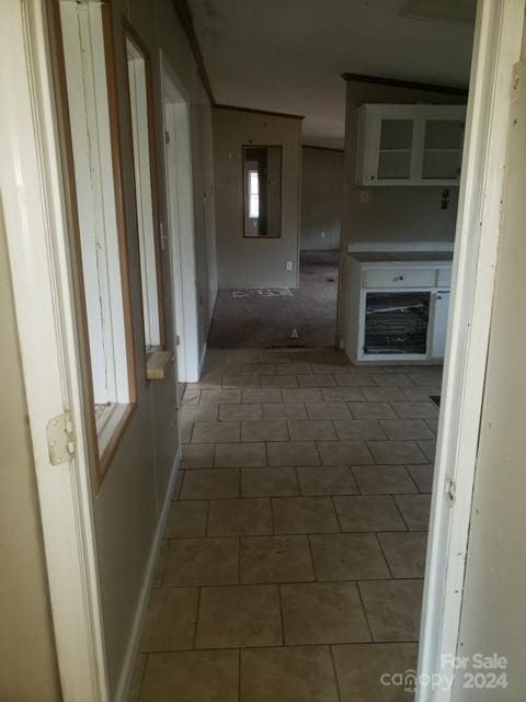 hallway with dark tile patterned flooring