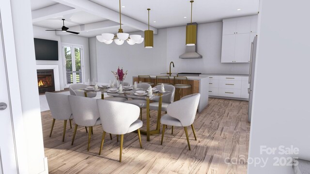 dining room with a warm lit fireplace, beamed ceiling, light wood-type flooring, and recessed lighting