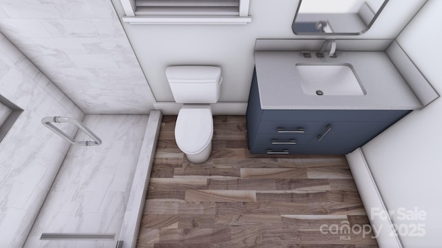 bathroom with tiled shower, vanity, and toilet