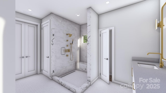 bathroom featuring a stall shower, a sink, and recessed lighting