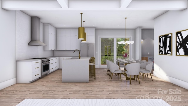 kitchen featuring stainless steel range, light wood finished floors, light countertops, a sink, and wall chimney exhaust hood