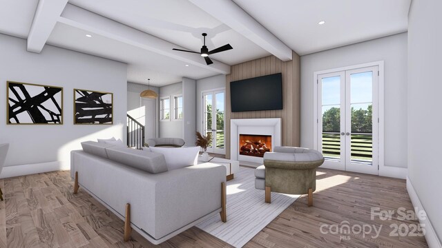 living area with a large fireplace, baseboards, beamed ceiling, and wood finished floors